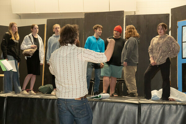 Mr. Button directs students at Bentley School rehearsing scenes from the upcoming production of Ax of Murder, a mystery-comedy dinner theatre running June 12 and 13. 