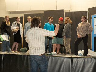 Mr. Button directs students at Bentley School rehearsing scenes from the upcoming production of Ax of Murder, a mystery-comedy dinner theatre running June 12 and 13.