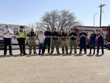 École Lacombe Upper Elementary School student Drennan Blair stands with local emergency crews from Lacombe Police Service, Lacombe Fire Department, and EMS from Medcor Canada, who all participated in a Mock Incident May 2 at École Lacombe Upper Elementary