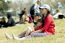 Sarah Olson, with Gabe and Theo, sit and listen to speakers and song in recognition of Missing and Murdered Indigenous Women, Girls and Two-Spirited People, during an event at Centennial Park in Ponoka, May 5, 2022.